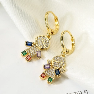 Gold-plated boy and girl drop earrings with colorful zircon stones on white silk