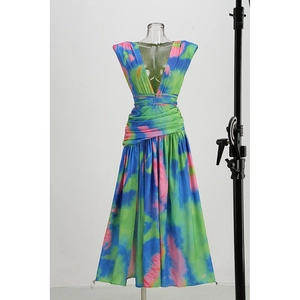 Colorful tie-dye maxi dress with deep V-neck and pleated waist on a display mannequin