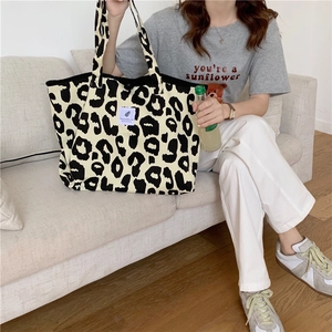 Detailed macro view of large leopard print canvas tote bag with spacious interior compartment