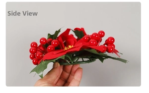 Close-up of artificial red berries and fabric petals on a Christmas candle ring