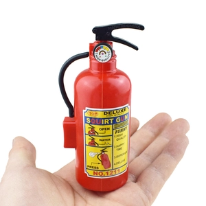 Detail of red fire extinguisher squirt gun with label text held in hand for scale