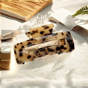 Tortoiseshell acetate hair claw clip for women featuring a minimalist rectangular design