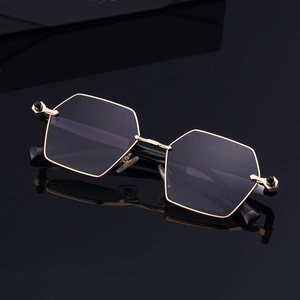 Chic black and gold hexagonal metal frame sunglasses with dark resin lenses in 45-degree view