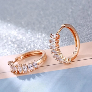 Close-up of rose gold hoop earrings with marquise-cut white cubic zirconia crystals