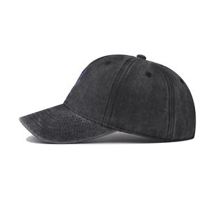 Detailed side view of washed black cotton baseball cap with purple orchid embroidery