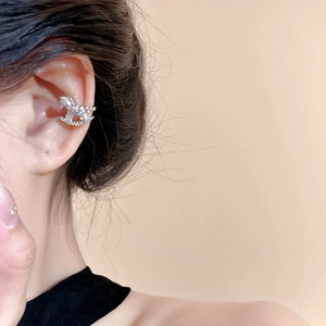 Elegant silver rocking horse ear cuff with zircon inlay shown on model's ear