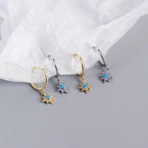 Detailed macro view of S925 silver star opal hoop earrings in gold and silver finishes