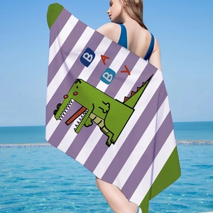 Detail of baby beach towel with green crocodile and purple stripes by a pool