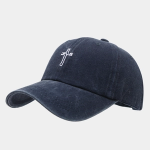 Detailed embroidery of a white cross and Jesus text on a washed navy blue cotton baseball cap