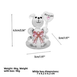 Detailed view of crystal bear figurine with pink bow and It's a girl heart wand