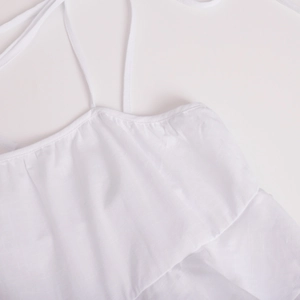 Detail of white tiered ruffle neckline and fine vertical texture on summer dress straps