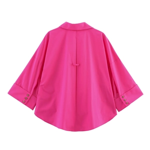 Detail view of fuchsia poplin shirt back featuring box pleat and wide cuff accents