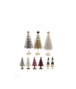 Detailed view of various mini wooden Christmas trees in assorted colors and festive styles