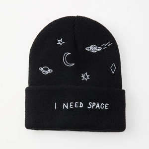 Black knitted beanie with I NEED SPACE embroidery and space patterns on a white background