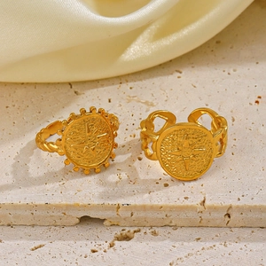 18K gold plated vintage starburst signet rings on a beige stone base and satin fabric