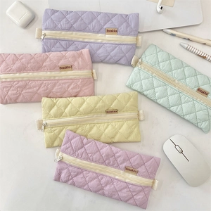 Close-up of quilted pastel pencil cases in five candy colors with zip closure