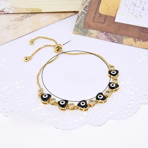 Detail of 18k gold plated evil eye bracelet with cubic zirconia and slide clasp