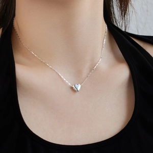 Elegant S925 sterling silver heart pendant necklace on model neck showing collarbone style