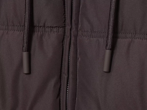 Detail of dark brown jacket featuring textured fabric, zipper, and matching drawstrings