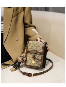 Detail of embroidered canvas mini shoulder bag with bear print and cute bear charm pendant