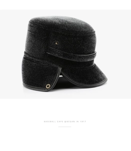 Detail of warm black faux fur winter hat for men featuring ear flaps and leather piping