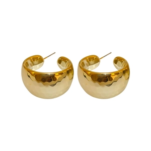 Statement C-shaped chunky gold earrings with hammered metal texture for a bold geometric look