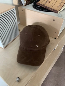 Dark brown brushed cotton baseball cap with Colorado embroidery on a wooden surface