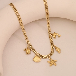 Detailed view of golden woven chain featuring sea turtle shell starfish and dolphin charms