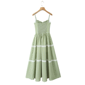 Detail of green plaid sundress featuring delicate white lace trim and gathered waist