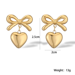 Detail view of gold bow heart earrings with measurements 2.5cm length and 13g weight