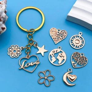Detailed macro shot of golden metal alloy charms with Love heart and flower patterns