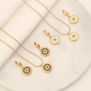 Detailed macro view of gold jewelry set with green gems and pearls on marble tray