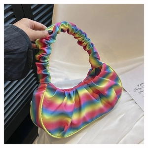 Detail of colorful rainbow pleated dumpling bag with vibrant gradient texture and handle