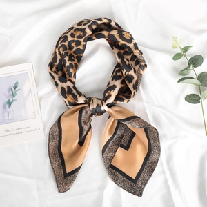 Elegant leopard print silk scarf with brown geometric border on white silk background