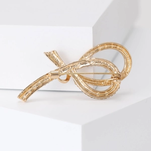 Elegant gold ribbon bow brooch with crystal accents for sweaters and suits