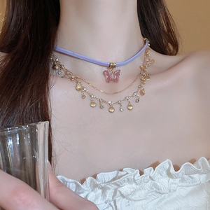 Three-layer butterfly necklace with pink crystal pendant and shell charms in gold finish