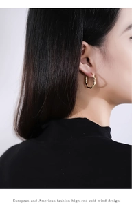 Close-up of S925 silver golden irregular wave texture earrings worn on model's ear