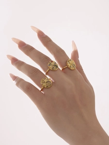 Detail of gold evil eye rings with colorful 5A zircon inlay worn by a model