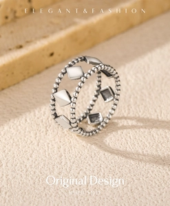 Detail shot of vintage geometric S925 sterling silver ring on textured surface