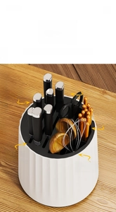 Rotating kitchen knife holder featuring multi-functional slots for utensils and shears