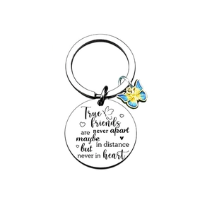 Close-up of friendship stainless steel keychain with engraved quote and butterfly charm