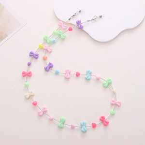 Detail of macaron pastel bow and heart bead glasses chain with secure metal clips