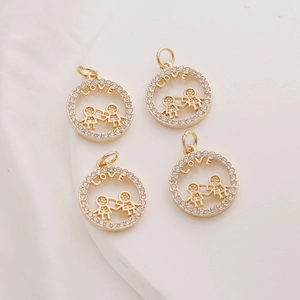 Detailed macro view of 14K gold-plated round charms with LOVE engraving and zircon inlay
