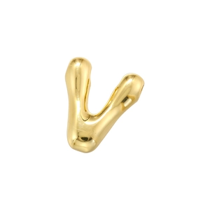 Macro view of a gold bubble V-letter charm with polished mirror finish for jewelry making