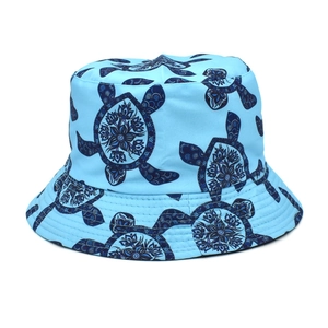 Detail of blue reversible bucket hat featuring intricate mandala sea turtle patterns