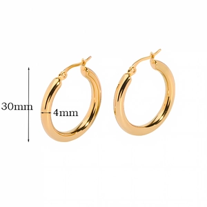 Detail view of 30mm gold hoop earrings with 4mm tube thickness on white background