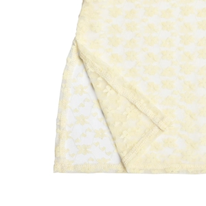 Detailed close-up of beige lace fabric texture and slit hem of the summer A-line dress