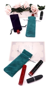 Detail view of purple and dark green velvet drawstring bags for jewelry and cosmetics