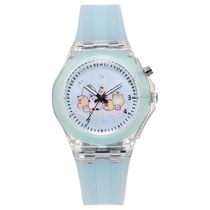 Detail of blue silicone kids watch with unicorn dial and colorful luminous LED spinning top