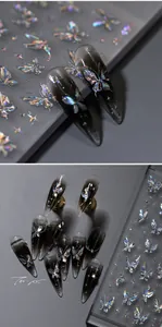 Macro detail of iridescent laser butterfly nail stickers with gothic dark star elements